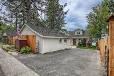 a house with a white garage and a fence at Beach Haven Lakefront - On a Sandy Beach with Guest House in Kings Beach