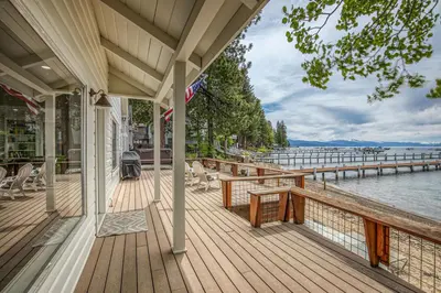 a porch of a house with a view of the water at Beach Haven Lakefront - On a Sandy Beach with Guest House in Kings Beach