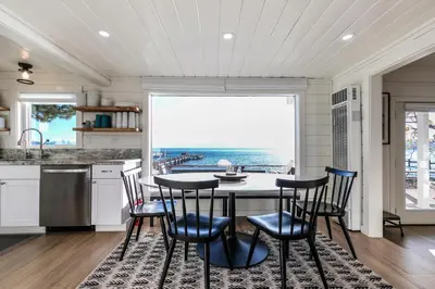 a kitchen with a table and chairs and a large window at Beach Haven Lakefront - On a Sandy Beach with Guest House in Kings Beach