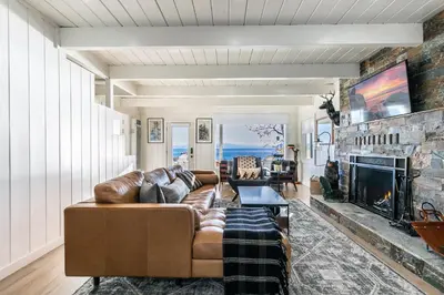 a living room with a couch and a fireplace at Beach Haven Lakefront - On a Sandy Beach with Guest House in Kings Beach