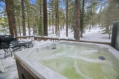 a hot tub in the snow in the woods at 4 Bedroom Home at 392 Skidder Trail home in Truckee