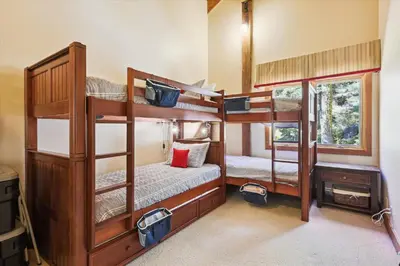 a room with three bunk beds in a house at Alpine Adventure- Shuttle to Ski Lifts- Hot Tub- Pet Friendly in Alpine Meadows