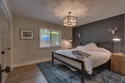 a bedroom with a bed and a window at Antler House- Quiet, Charming Cabin w Cozy Fireplace, Close to Skiing in Tahoe City