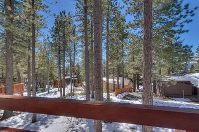 a cabin in the woods with snow on the ground at Base Camp at Dollar Point by Tahoe Getaways - Hot Tub, Large Deck, Wood Fireplace, Short Drive to Ski Resorts! in Tahoe City