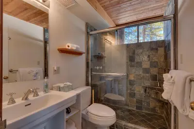 a bathroom with a shower and a toilet and a sink at Base Camp at Dollar Point by Tahoe Getaways - Hot Tub, Large Deck, Wood Fireplace, Short Drive to Ski Resorts! in Tahoe City