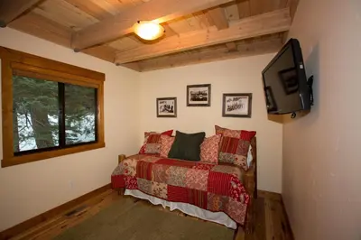 a bedroom with a bed and a tv on the wall at Away on Allenby by Tahoe Getaways - 3BR, Dog Ok, Close to Northstar! in Tahoe Vista