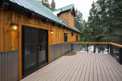 a large wooden deck next to a house at Away on Allenby by Tahoe Getaways - 3BR, Dog Ok, Close to Northstar! in Tahoe Vista