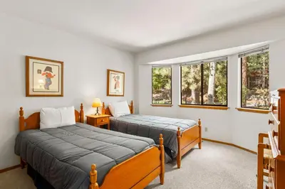 two beds in a room with two windows at 1 Sky Lake - walk to town in Incline Village
