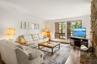 a living room with a couch and a tv at 1 Sky Lake - walk to town in Incline Village