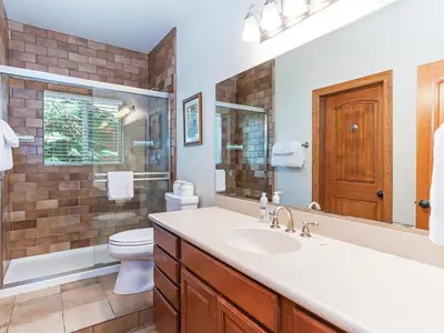 a bathroom with a sink and a toilet and a mirror at Amazing mountain setting in Incline Village