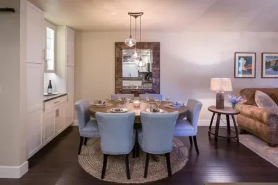 a dining room with a table and blue chairs at 101 McCloud - Simply Elegant in Incline Village