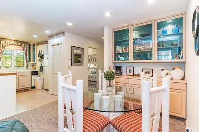a dining room with a glass table and chairs at 107 McCloud - Highly Sought After Complex in Incline Village