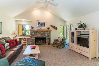 a living room with a couch and a fireplace at 107 McCloud - Highly Sought After Complex in Incline Village