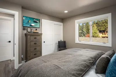 a bedroom with a bed and a window and a dresser at 128 McCloud - Luxury Couples Retreat in Incline Village