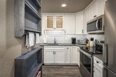 a kitchen with white cabinets and a sink at 128 McCloud - Luxury Couples Retreat in Incline Village