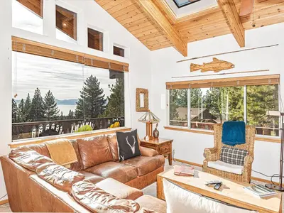 a living room with a couch and a table at Fantastic Lakeview house with large decks! in Incline Village