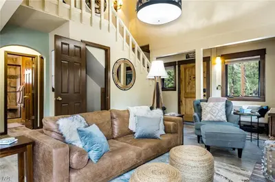 a living room with a brown couch and blue pillows at 1331 Zurich Lane - Modern Mountain Chalet in Incline Village