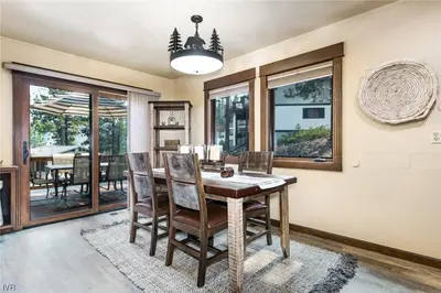 a dining room with a wooden table and chairs at 1331 Zurich Lane - Modern Mountain Chalet in Incline Village
