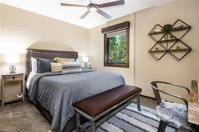 a bedroom with a bed and a ceiling fan at 1331 Zurich Lane - Modern Mountain Chalet in Incline Village