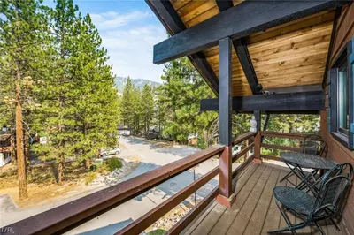 a balcony with two chairs and a table on a house at 1331 Zurich Lane - Modern Mountain Chalet in Incline Village