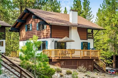 a home with a wrap around porch and a deck at 1331 Zurich Lane - Modern Mountain Chalet in Incline Village