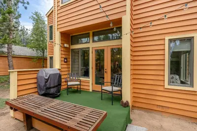 a porch with a bench and chairs on a house at 153 McCloud The perfect location! Enjoy the sun drenched deck in Incline Village