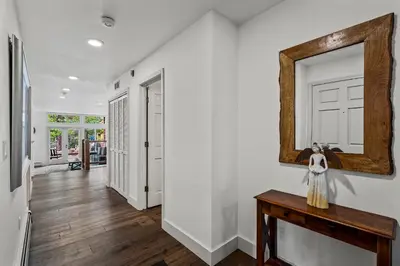 a hallway with a mirror and a wooden table at 153 McCloud The perfect location! Enjoy the sun drenched deck in Incline Village