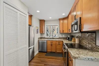 a kitchen with wooden cabinets and stainless steel appliances at 147 McCloud - The Perfect McCloud Getaway in Incline Village