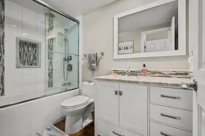 a white bathroom with a shower and a toilet at 147 McCloud - The Perfect McCloud Getaway in Incline Village
