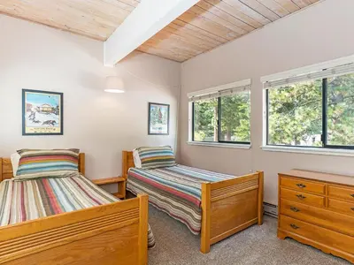 two beds in a room with two windows at 214 Forest Pines Nicely Decorated 4 Bedroom Condo in Incline Village