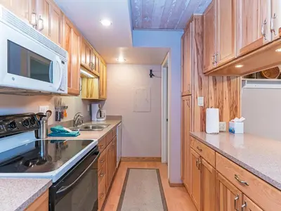 a kitchen with wooden cabinets and a sink and a stove at 214 Forest Pines Nicely Decorated 4 Bedroom Condo in Incline Village