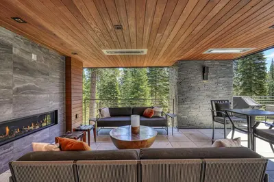 a living room with a couch and a fireplace at Elegance at Schaffer's Mill - Luxury 4 BR, Private Hot Tub, Pet Friendly! in Truckee