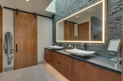 a bathroom with two sinks and a mirror at Elegance at Schaffer's Mill - Luxury 4 BR, Private Hot Tub, Pet Friendly! in Truckee