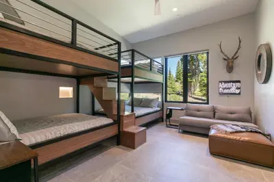 a room with two bunk beds and a couch at Elegance at Schaffer's Mill - Luxury 4 BR, Private Hot Tub, Pet Friendly! in Truckee