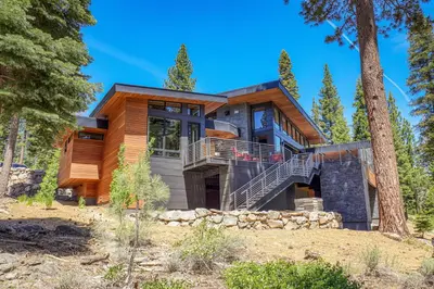 a house in the woods with a tree at Elegance at Schaffer's Mill - Luxury 4 BR, Private Hot Tub, Pet Friendly! in Truckee