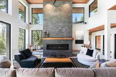 a living room with couches and a fireplace at Elegance at Schaffer's Mill - Luxury 4 BR, Private Hot Tub, Pet Friendly! in Truckee