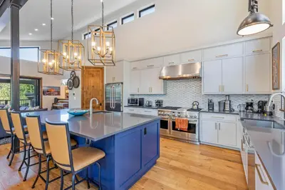 a kitchen with a large blue island in a kitchen at Harmony at Tahoe Donner - Ultra Modern 4 BR, Hot Tub, Game Room, Amenity Access in Truckee