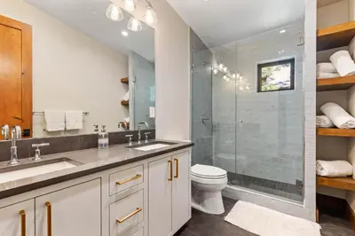 a bathroom with a sink and a toilet and a shower at Harmony at Tahoe Donner - Ultra Modern 4 BR, Hot Tub, Game Room, Amenity Access in Truckee