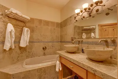 a bathroom with two sinks and a tub at Huckleberry Haven by Tahoe Getaways - Luxury Lake View 4BR in North Lake with Private Hot Tub in Carnelian Bay
