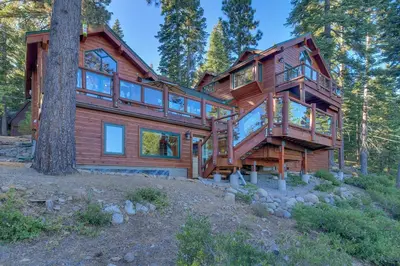 a large wooden house in the woods at Huckleberry Haven by Tahoe Getaways - Luxury Lake View 4BR in North Lake with Private Hot Tub in Carnelian Bay