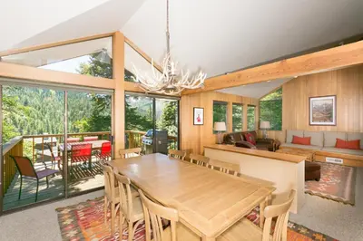 a dining room and living room with a table and chairs at Juniper at Alpine - Private Hot tub, Pet Friendly & Free Shuttle to Slopes in Olympic Valley