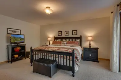 a bedroom with a bed and two night stands and a tv at Lake Haven at Dollar Point - Spacious 4 BR w Lake Views, Sauna, Near Ski Resorts! in Tahoe City