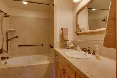 a bathroom with a tub and a sink and a mirror at Lake Haven at Dollar Point - Spacious 4 BR w Lake Views, Sauna, Near Ski Resorts! in Tahoe City