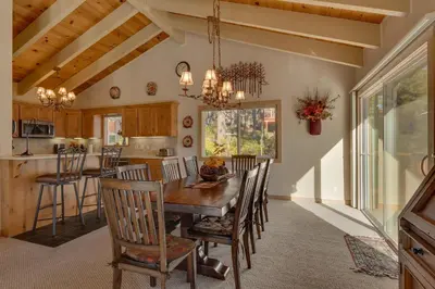 a kitchen and dining room with a wooden table and chairs at Lake Haven at Dollar Point - Spacious 4 BR w Lake Views, Sauna, Near Ski Resorts! in Tahoe City