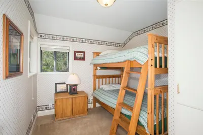 a bedroom with two bunk beds in a room at Lakeside Escape - Beautiful Lakefront, Pier, Wood Fireplace, Private Hot Tub in Tahoe Vista