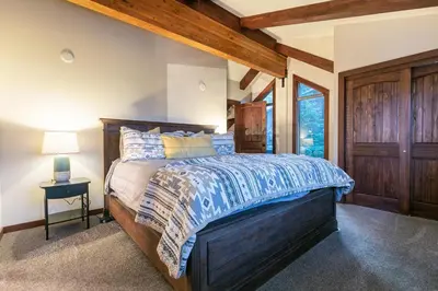 a bedroom with a large bed with a wooden headboard at Lake of the Sky at Dollar Point - Stunning 4BR,4BA w Lake Views, Hot Tub and Pet-friendly in Tahoe City