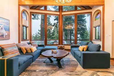 a living room with blue couches and a table at Lake of the Sky at Dollar Point - Stunning 4BR,4BA w Lake Views, Hot Tub and Pet-friendly in Tahoe City