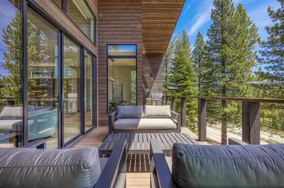 a patio with two couches on a deck at Larkspur Luxe at Northstar- 4 BR with Pool, Gym, Access - Walk to Village, Private Hot Tub in Truckee