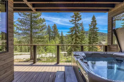 a view from the deck of a house with a hot tub at Larkspur Luxe at Northstar- 4 BR with Pool, Gym, Access - Walk to Village, Private Hot Tub in Truckee