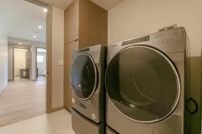 two washing machines sitting next to each other in a room at Larkspur Luxe at Northstar- 4 BR with Pool, Gym, Access - Walk to Village, Private Hot Tub in Truckee